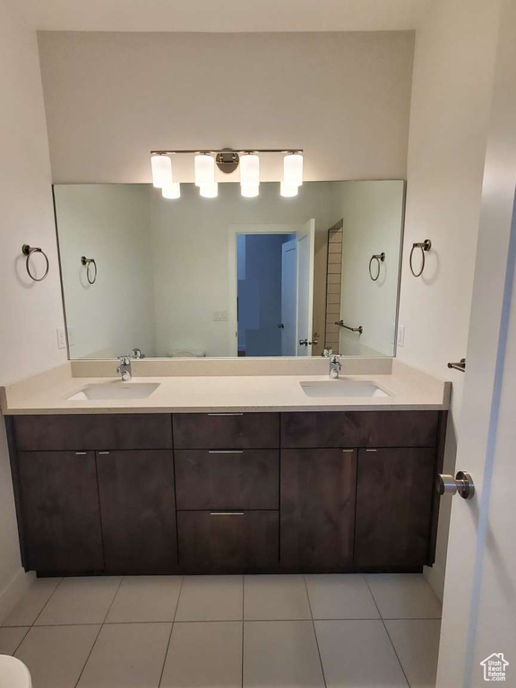 Full bath with double vanity and tile patterned floors