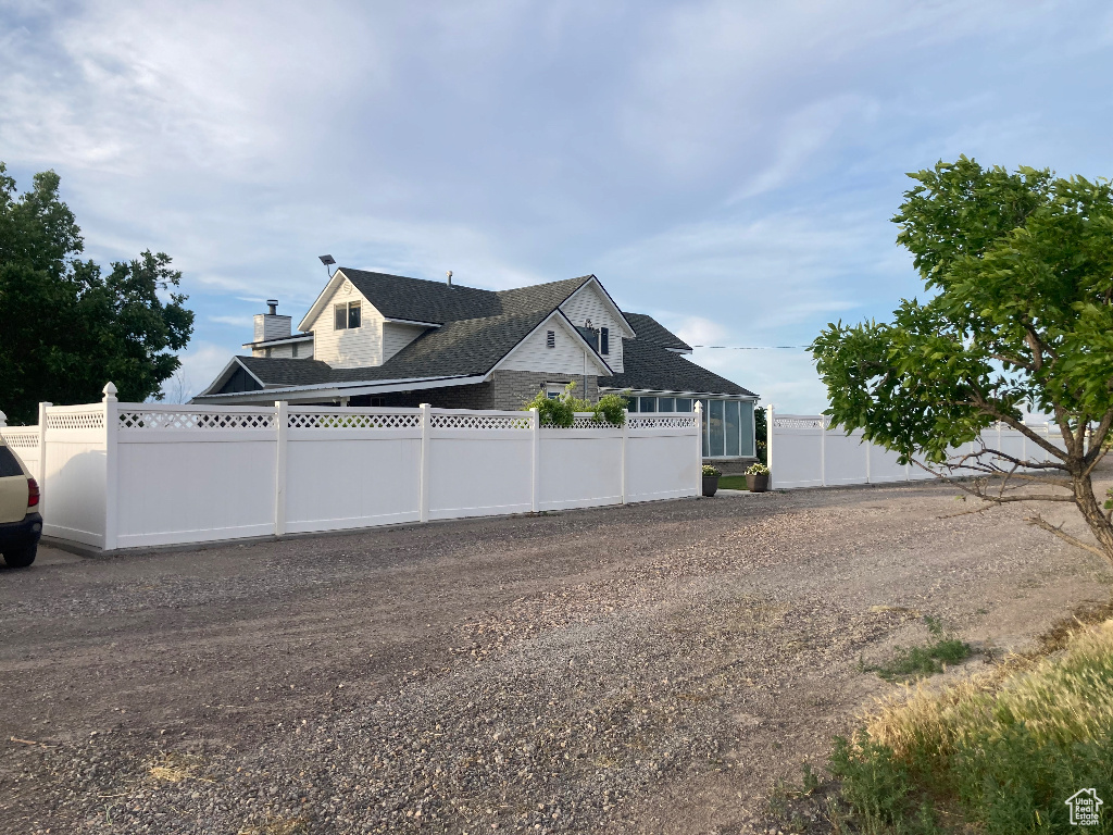 View of home's exterior with a shingled roof
