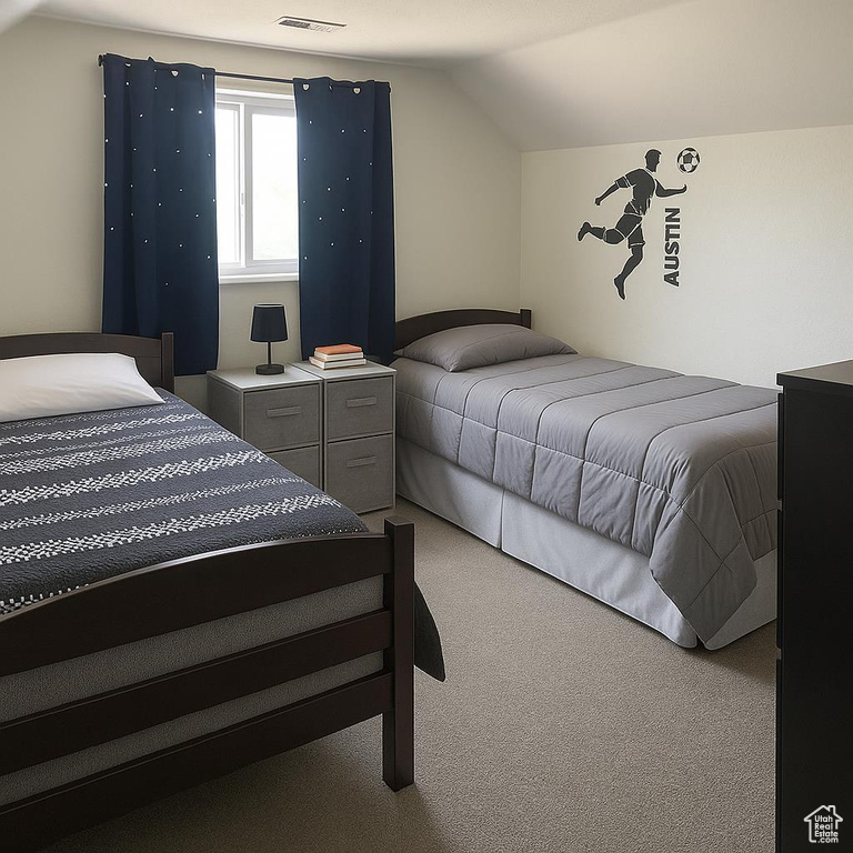 Carpeted bedroom with vaulted ceiling