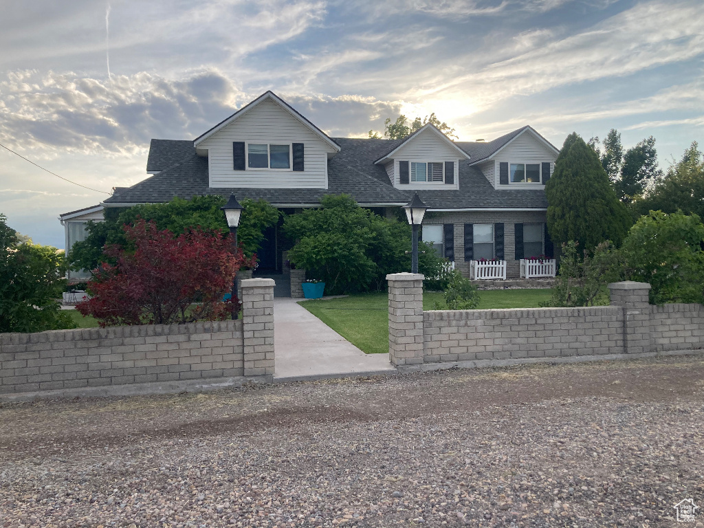 View of front of home featuring roof with shingles