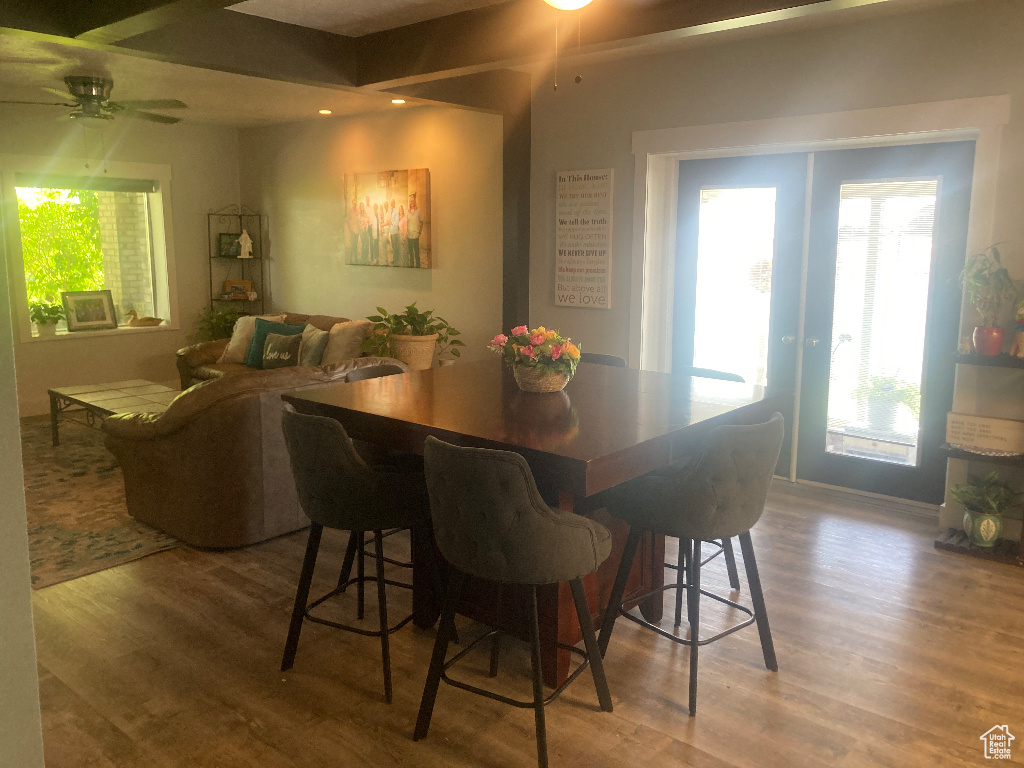 Dining area featuring wood finished floors, ceiling fan, french doors, and baseboards