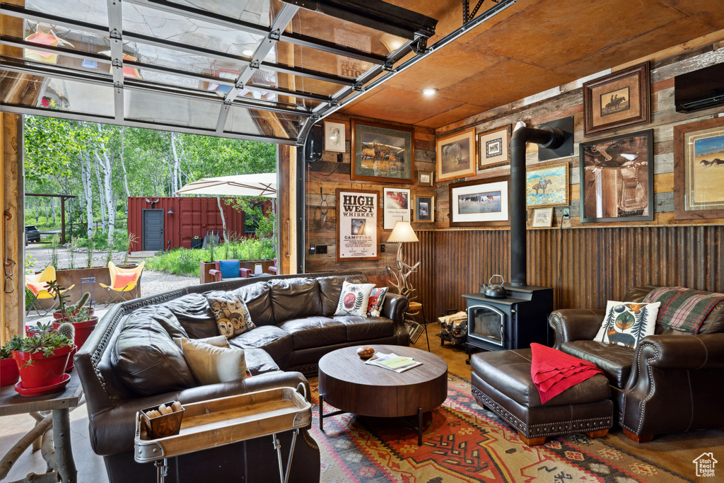 Living room with a wood stove and wooden walls