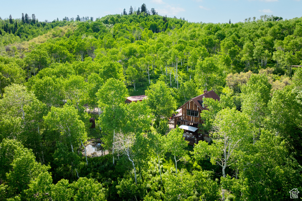 View from above of property featuring a heavily wooded area