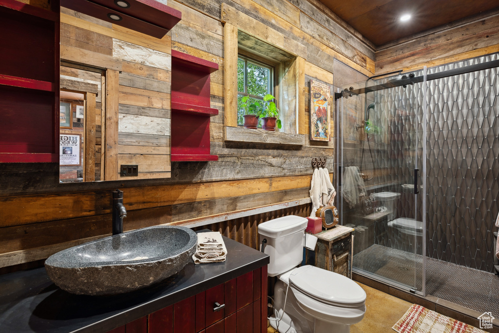 Bathroom with toilet, wooden walls, a shower stall, vanity, and recessed lighting