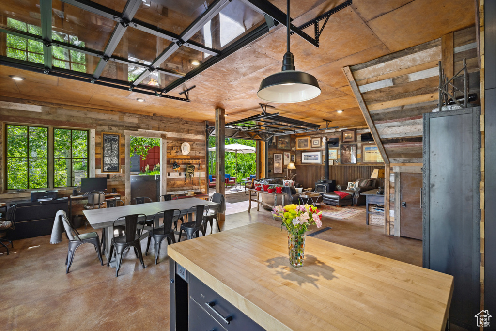 Dining space featuring concrete floors and wood walls