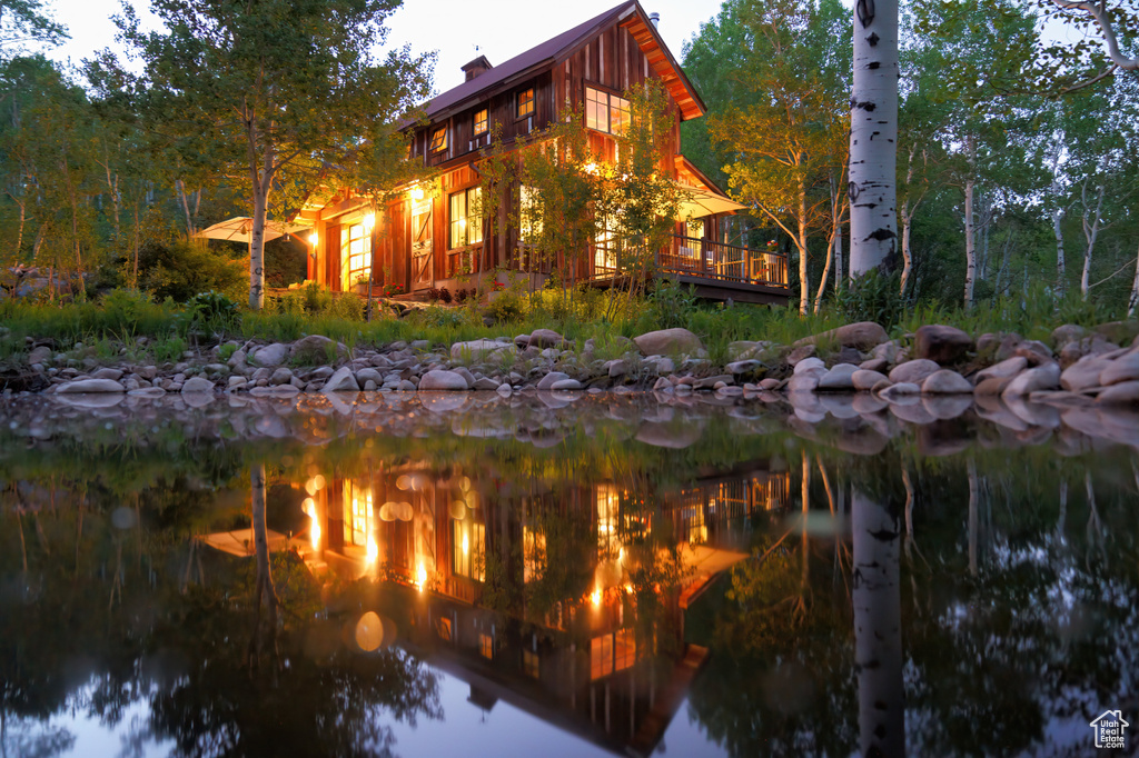 View of side of property with a water view and a chimney