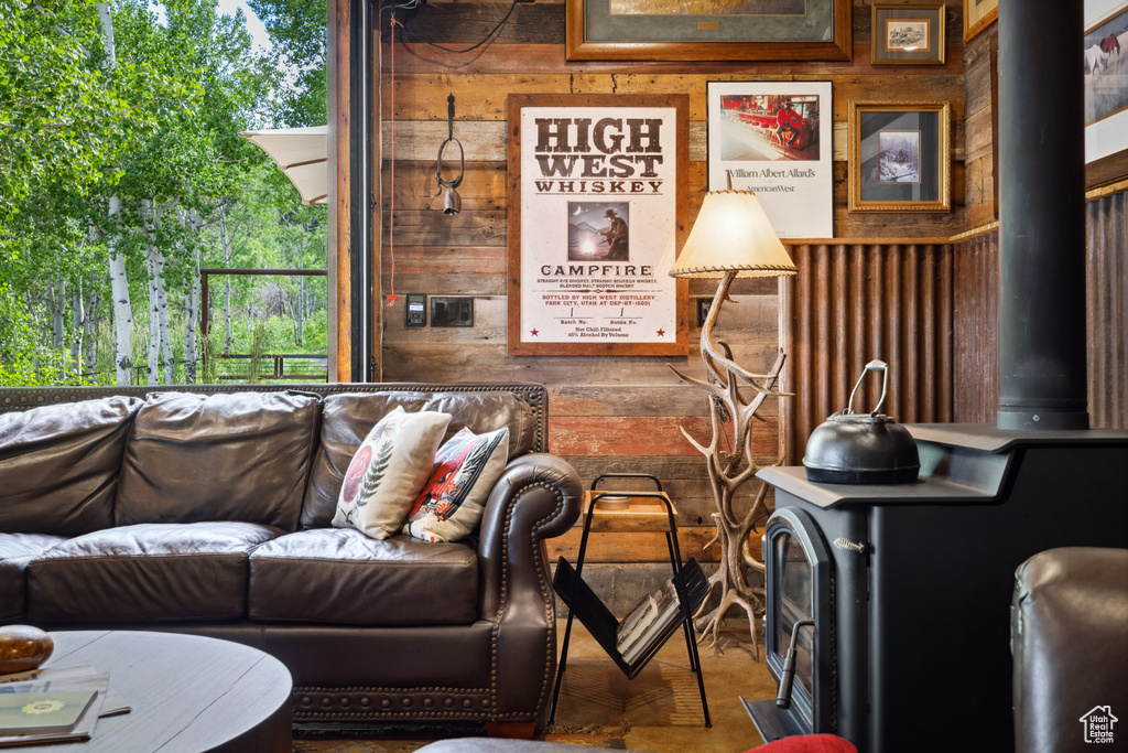 Living room featuring wood walls and a wood stove