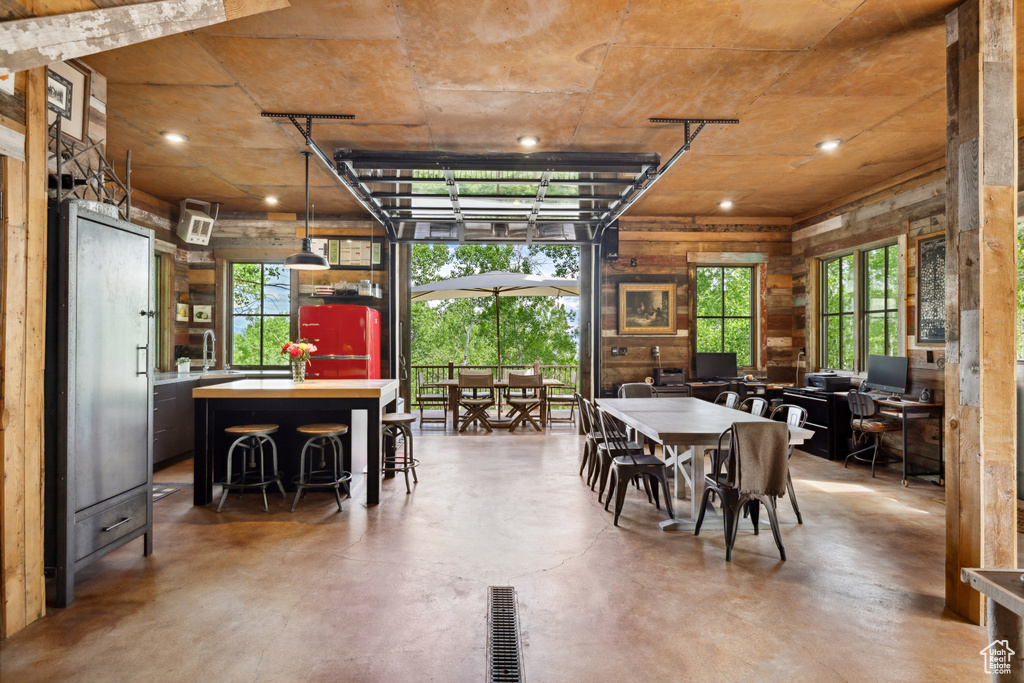 Dining room featuring concrete flooring and recessed lighting
