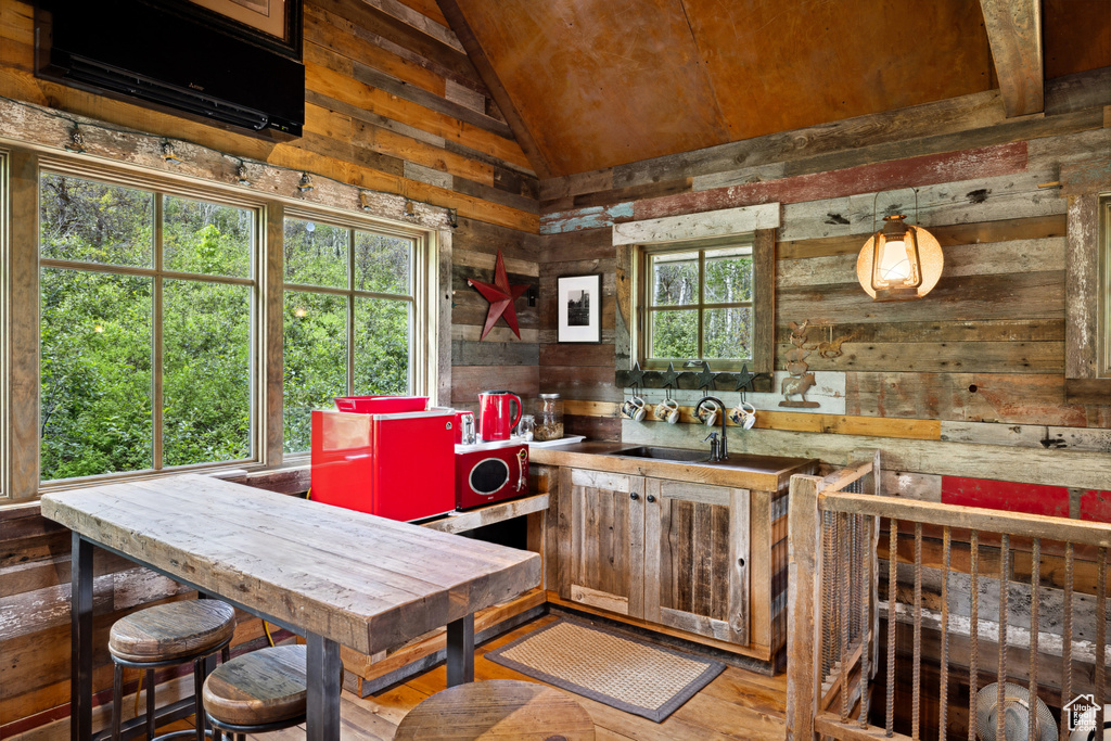 Kitchen with wooden walls and lofted ceiling