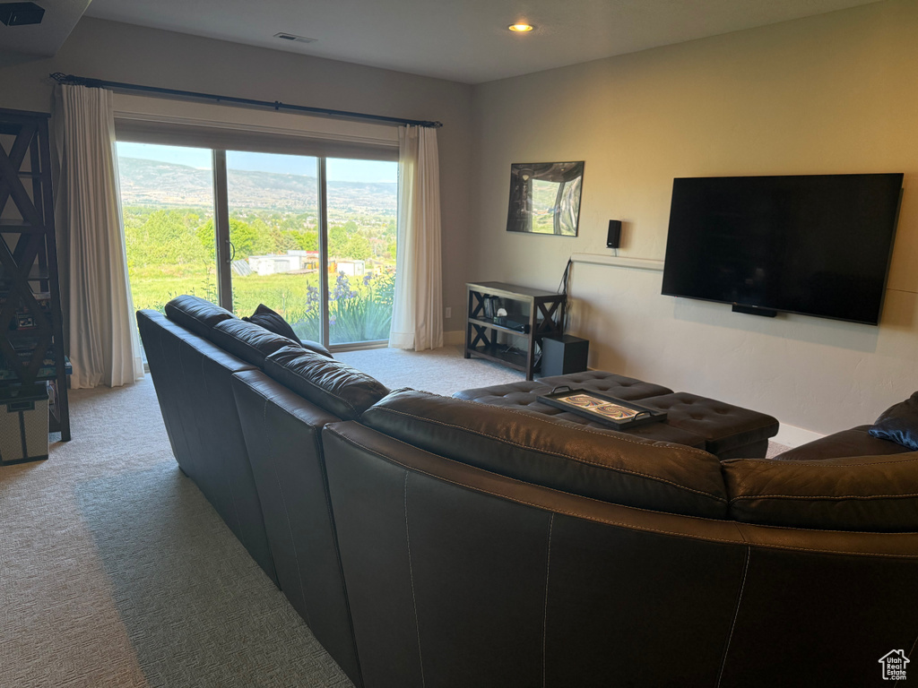 Carpeted living area with recessed lighting