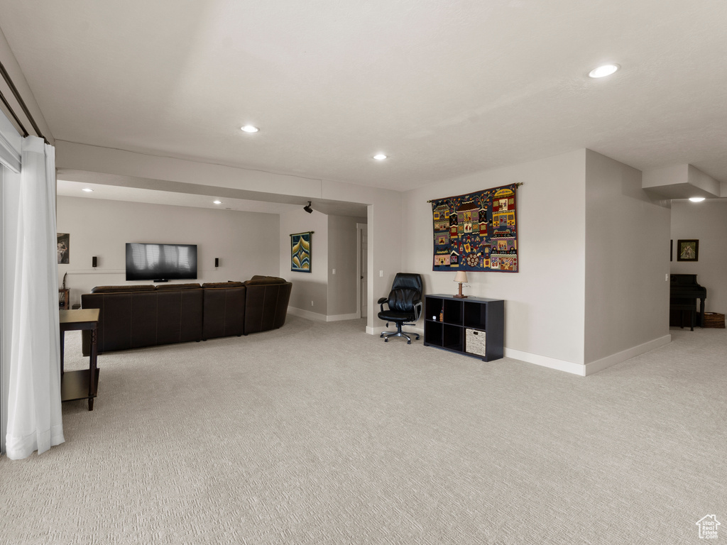 Carpeted living room with recessed lighting and baseboards