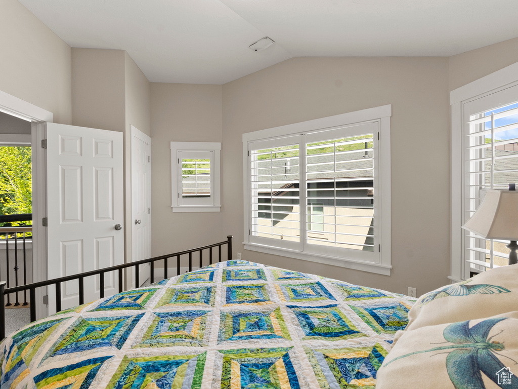 Bedroom with lofted ceiling