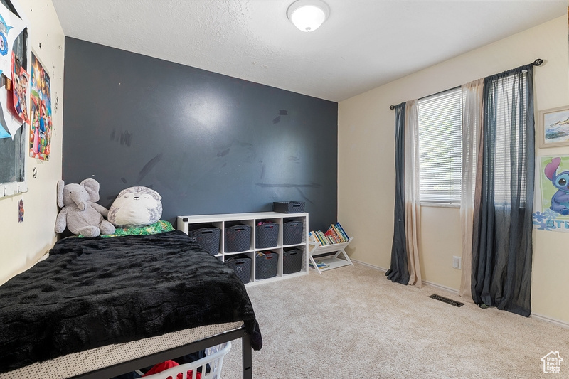 Carpeted bedroom featuring baseboards