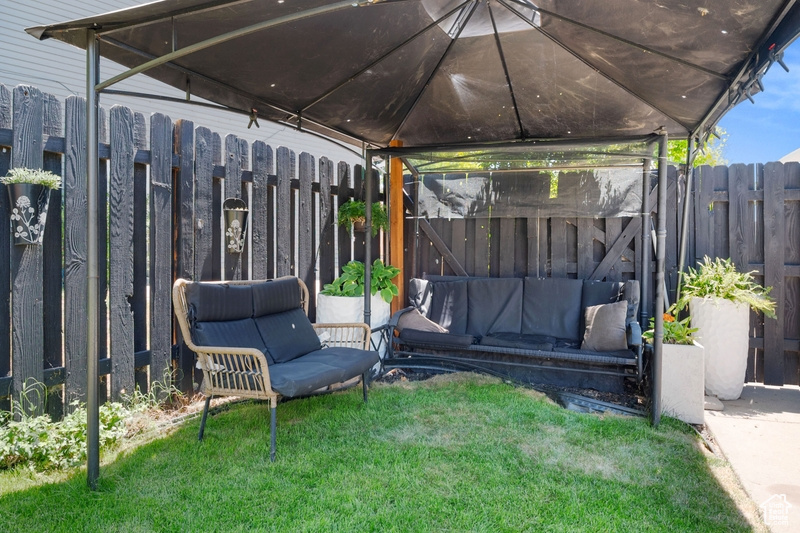 View of yard featuring an outdoor living space and a gazebo