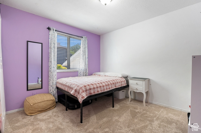 Carpeted bedroom with baseboards