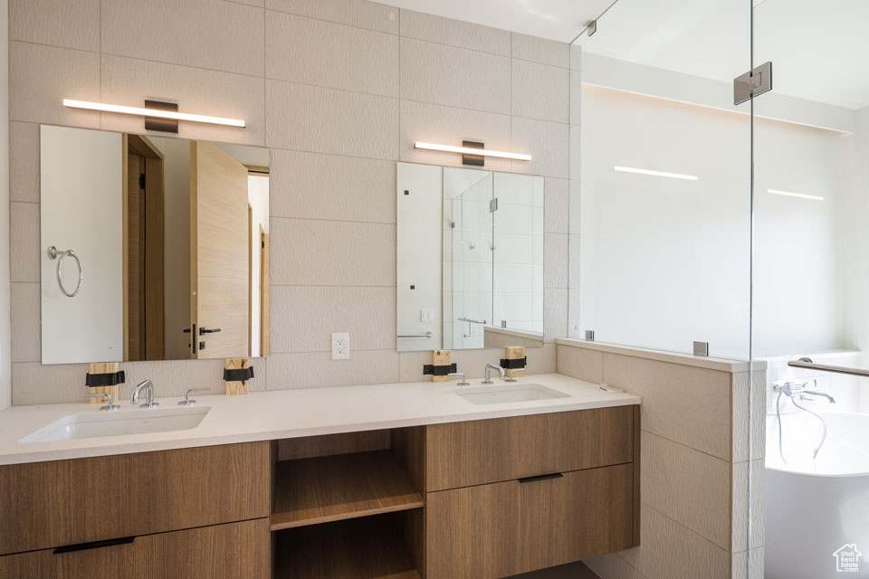 Bathroom with double vanity and a bathtub