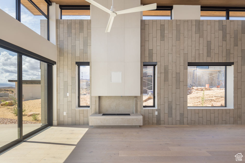 Common area with a towering ceiling and wooden walls