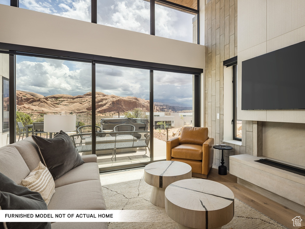 Living room featuring a high ceiling and wood finished floors