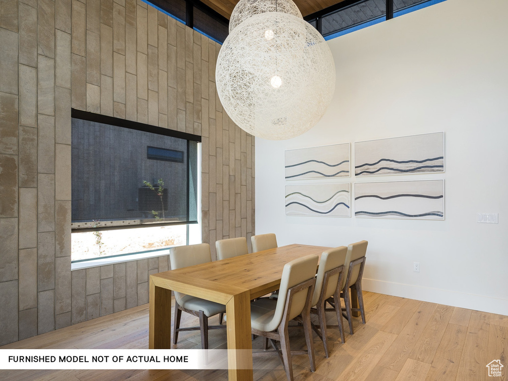 Dining room featuring light wood-style flooring and baseboards
