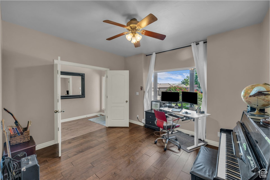 Home office with a ceiling fan and wood finished floors