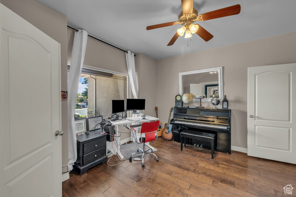 Home office with wood-type flooring and a ceiling fan
