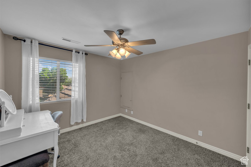Unfurnished office with ceiling fan and carpet floors
