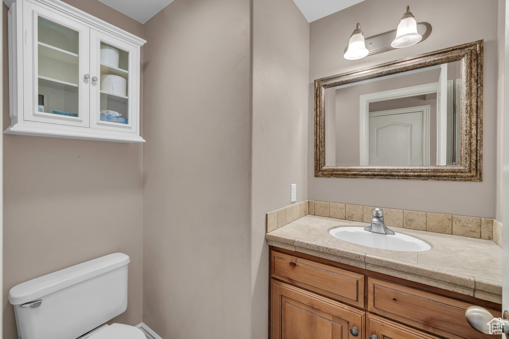 Half bathroom featuring toilet and vanity