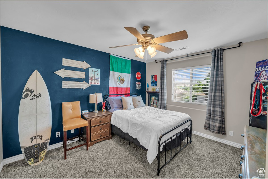 Carpeted bedroom with baseboards and ceiling fan
