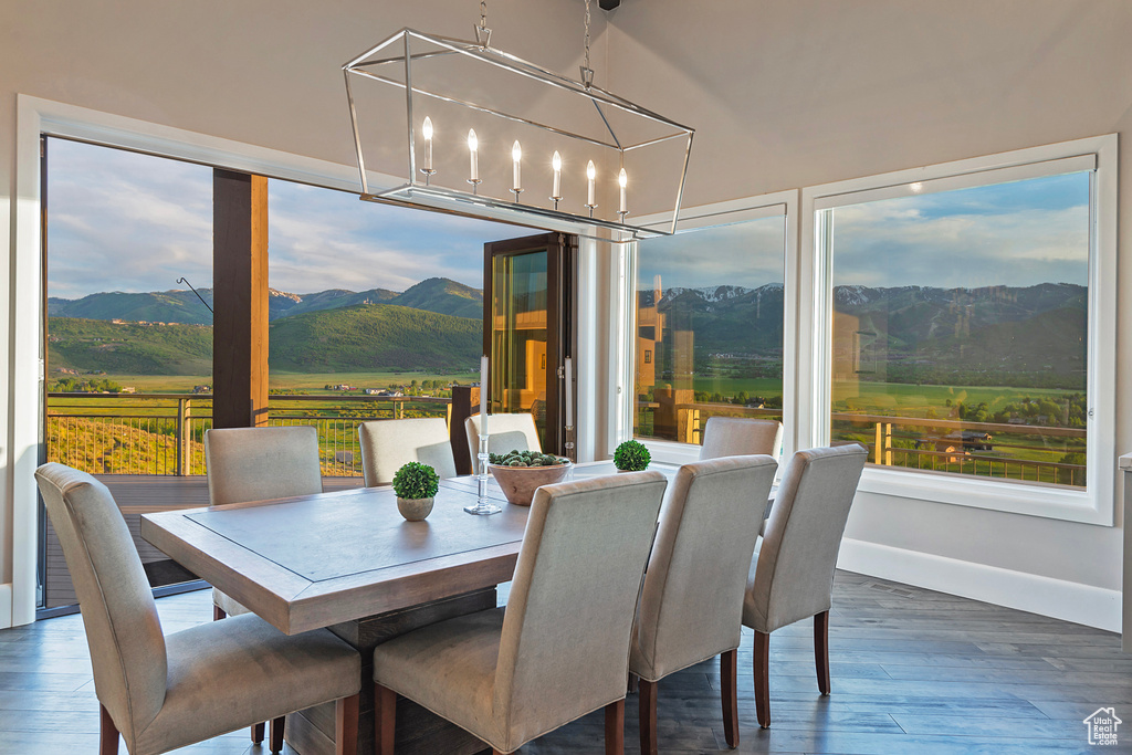 Dining room featuring a mountain view, wood finished floors, baseboards, and a chandelier