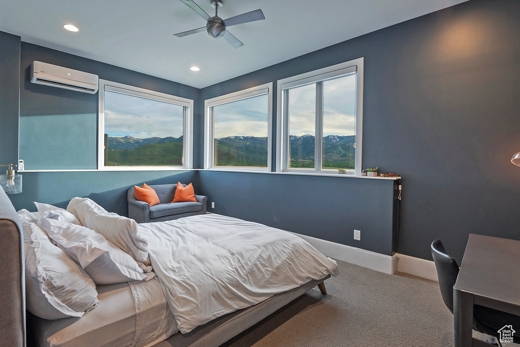Bedroom featuring a wall mounted AC, carpet flooring, a mountain view, recessed lighting, and baseboards