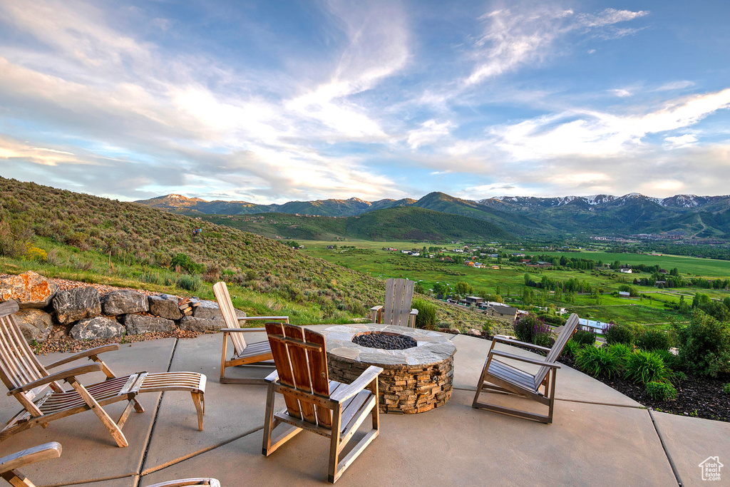 View of patio featuring a fire pit and a mountain view