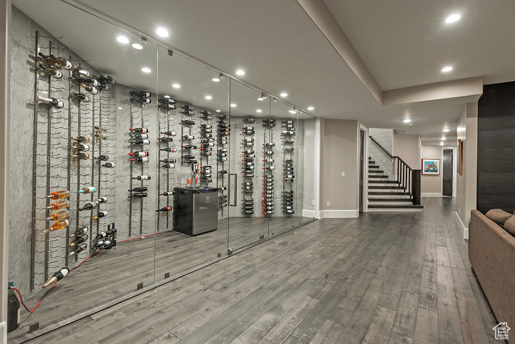 Wine area with recessed lighting, baseboards, and wood finished floors