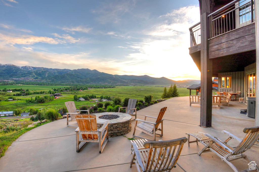 View of patio / terrace featuring a fire pit and a mountain view