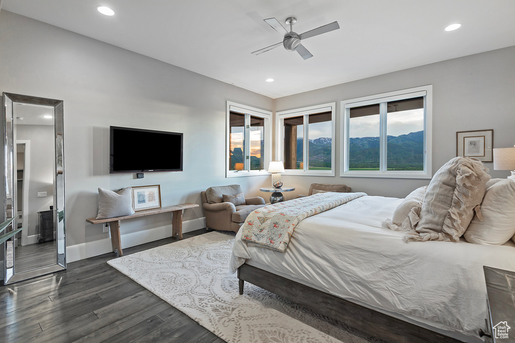 Bedroom with dark wood finished floors, recessed lighting, baseboards, and ceiling fan