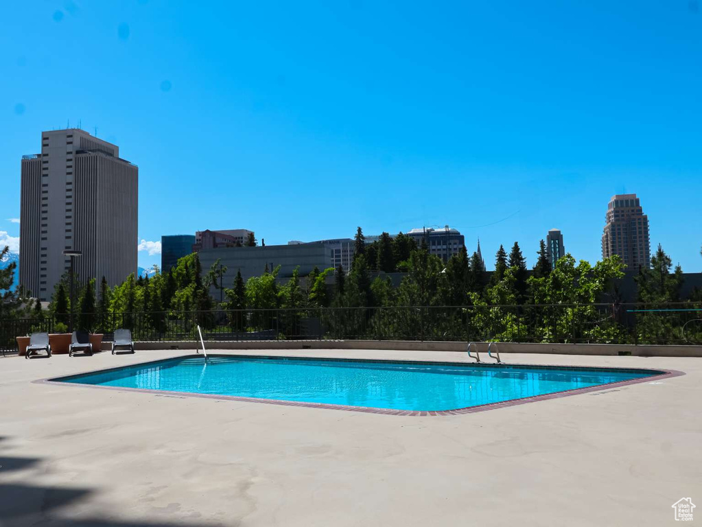 Community pool with a patio