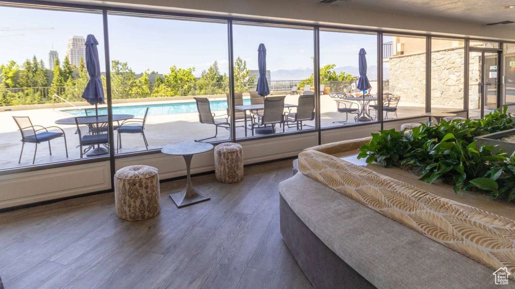 Living area with wood finished floors and healthy amount of natural light