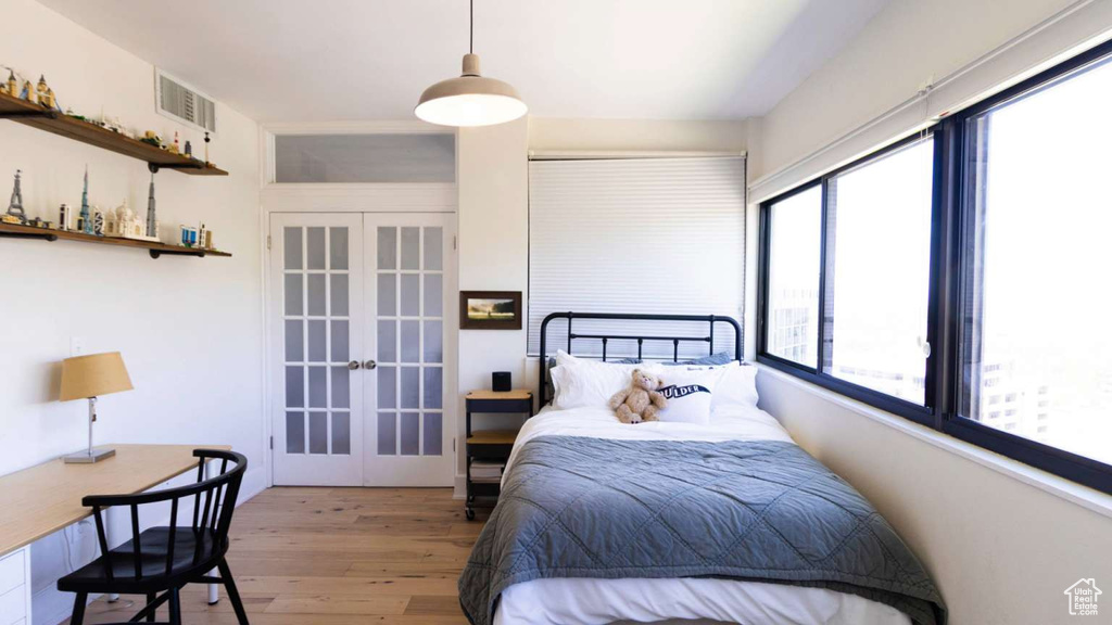 Bedroom featuring french doors and wood finished floors