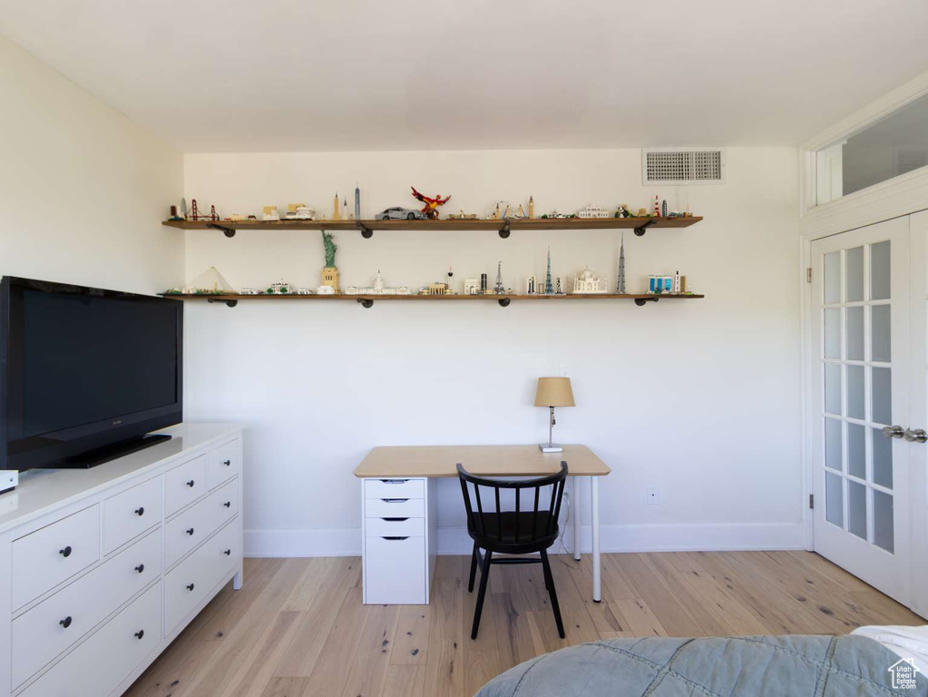 Bedroom with light wood-style flooring and baseboards