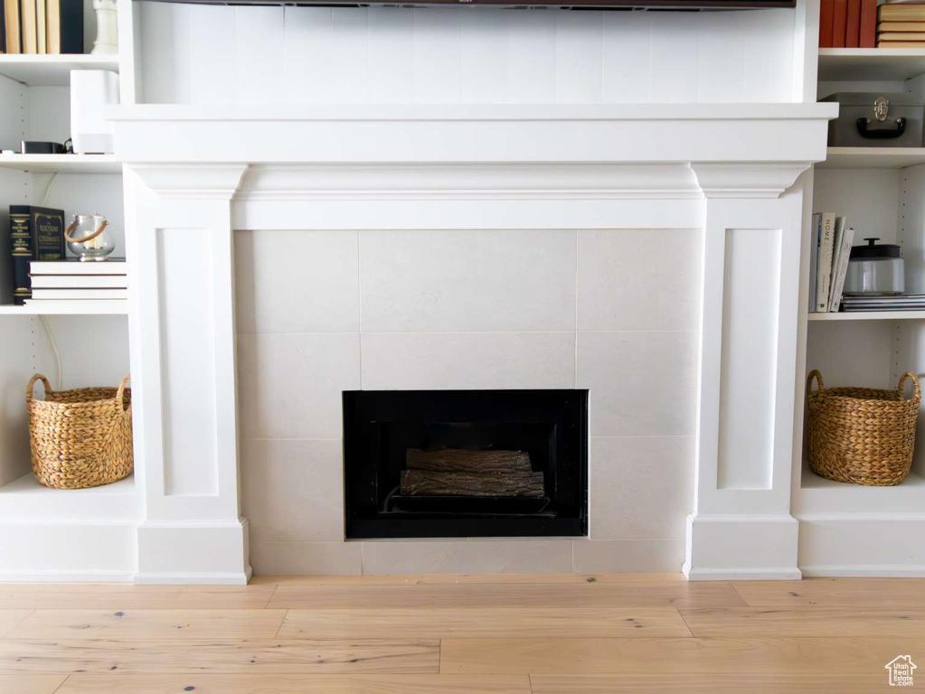 Detailed view of a fireplace and wood finished floors