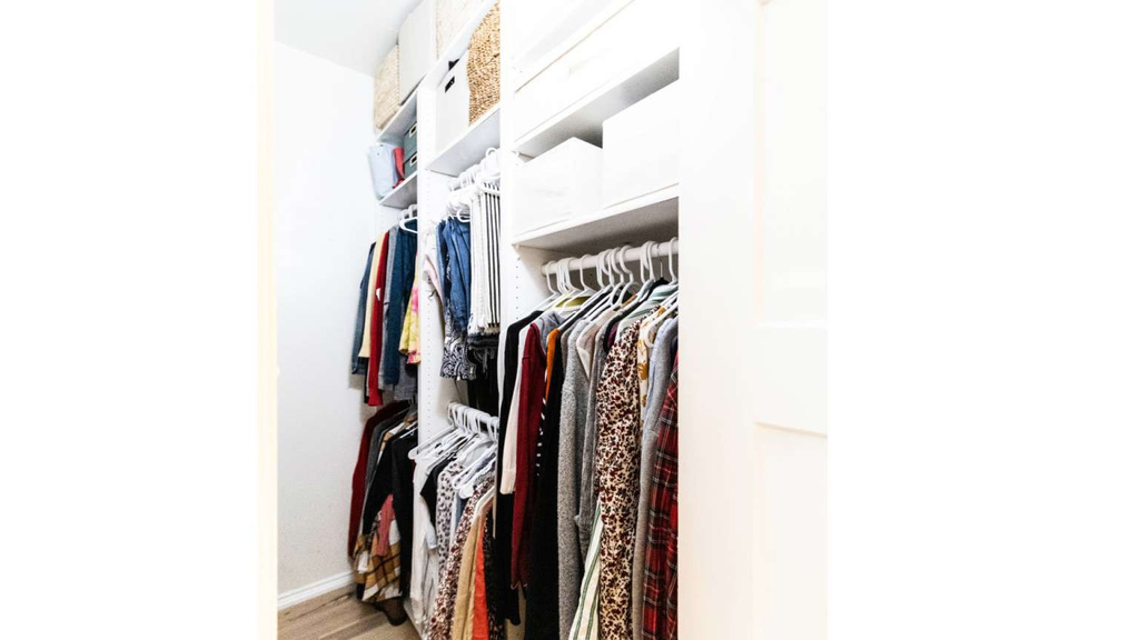 Walk in closet with wood finished floors