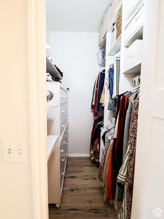Walk in closet featuring wood finished floors
