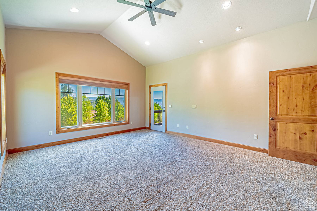Spare room featuring carpet floors, ceiling fan, baseboards, lofted ceiling, and recessed lighting