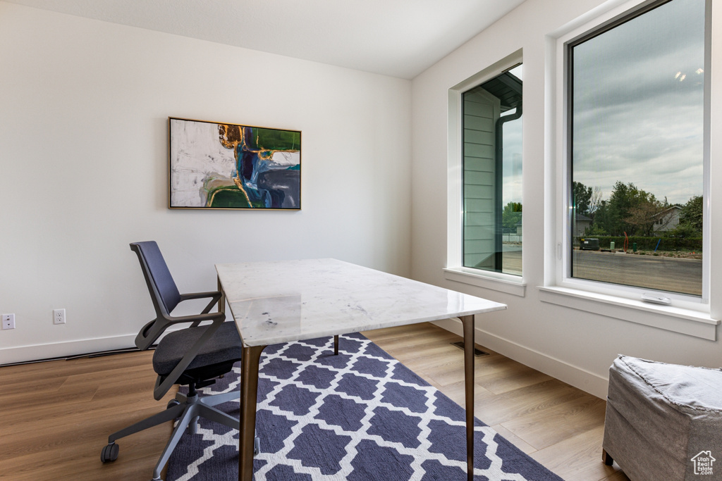 Office space featuring wood finished floors and baseboards