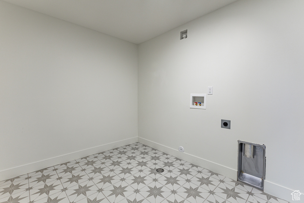 Clothes washing area with light floors, baseboards, washer hookup, laundry area, and electric dryer hookup