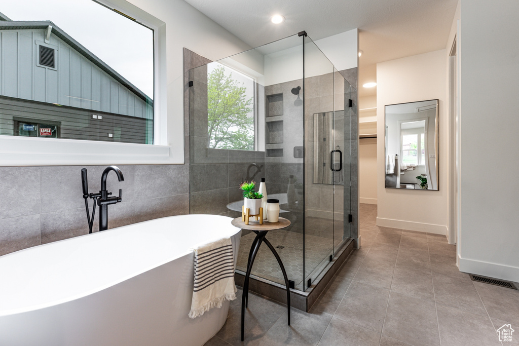 Full bathroom with recessed lighting, baseboards, a shower stall, tile patterned flooring, and a freestanding bath