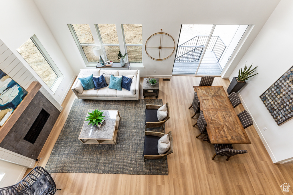 Living area with a high ceiling, baseboards, and wood finished floors