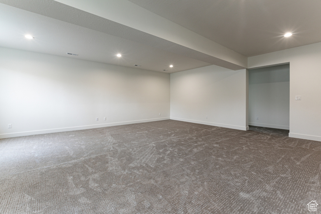 Carpeted empty room featuring baseboards, visible vents, and recessed lighting
