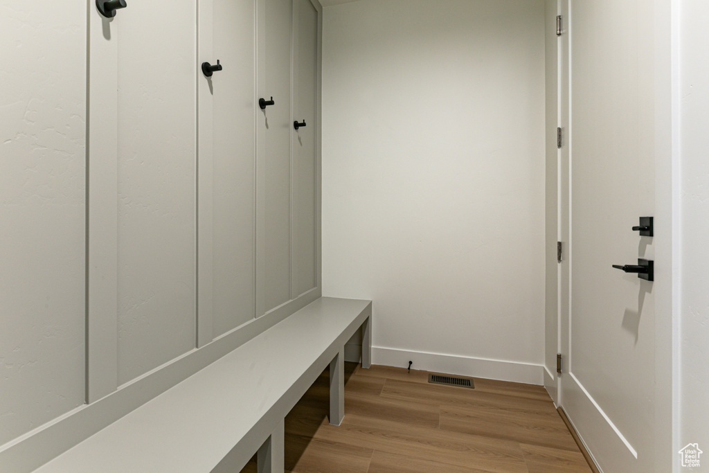 Mudroom with baseboards, light wood-style flooring, and visible vents