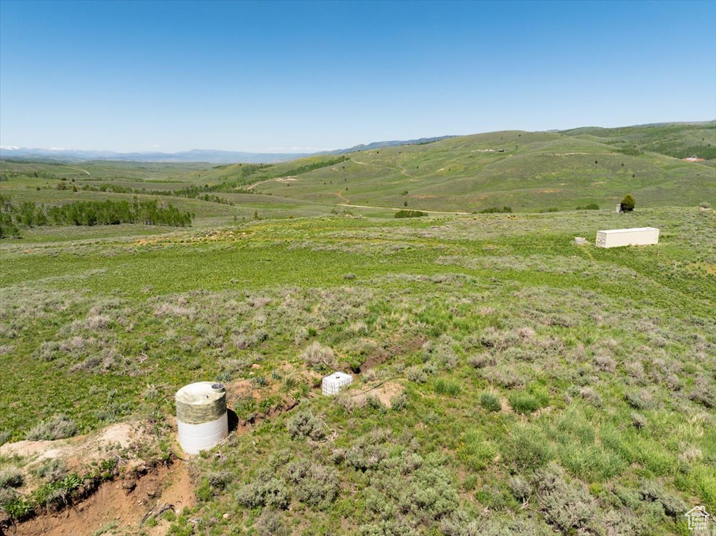View of mountain backdrop featuring rural landscape