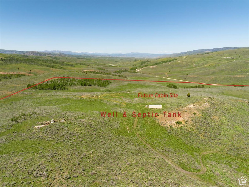 View of rural area with property boundaries highlighted and a mountainous background